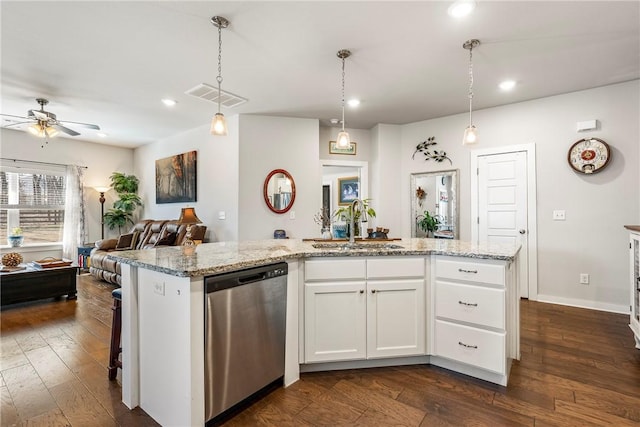 kitchen with dishwasher, dark wood-type flooring, visible vents, and a sink