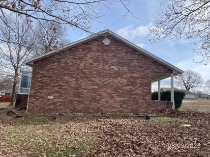 view of side of home with brick siding