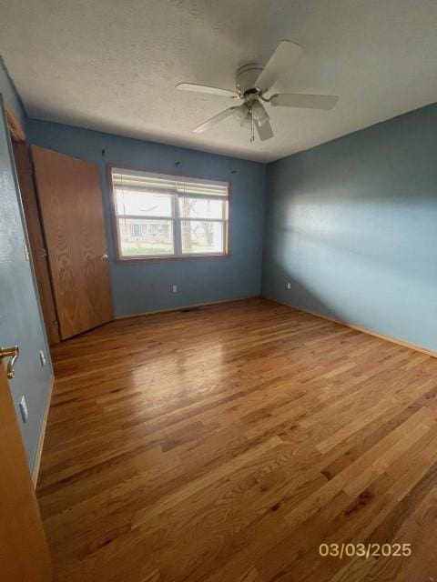 unfurnished bedroom with ceiling fan and wood finished floors