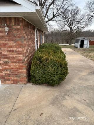 view of side of home with brick siding