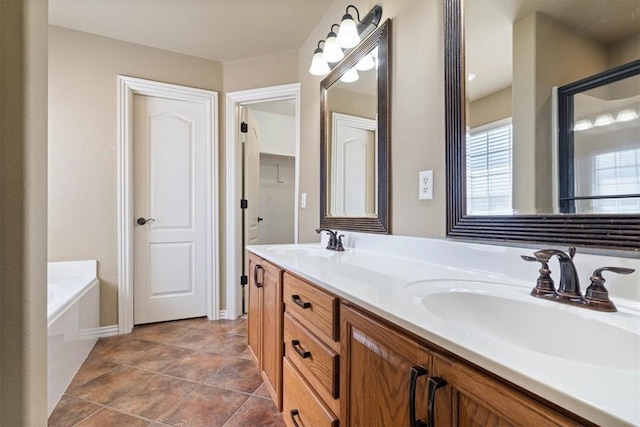 bathroom featuring a sink, a bath, double vanity, and tile patterned flooring