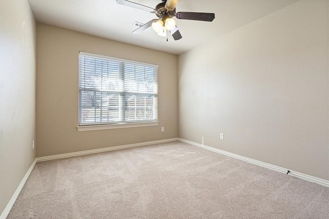 spare room featuring baseboards, ceiling fan, and carpet floors