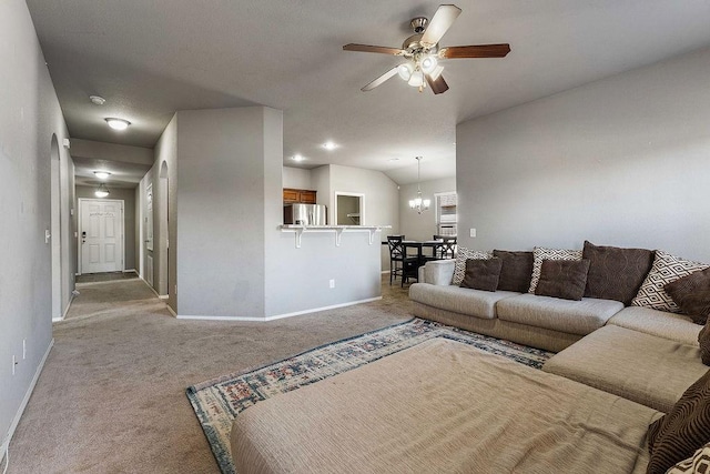 living area with lofted ceiling, ceiling fan with notable chandelier, light colored carpet, and baseboards