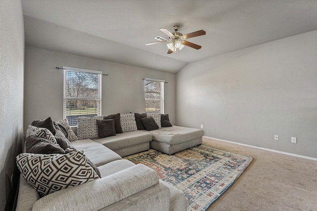 carpeted living room featuring a healthy amount of sunlight, baseboards, lofted ceiling, and ceiling fan