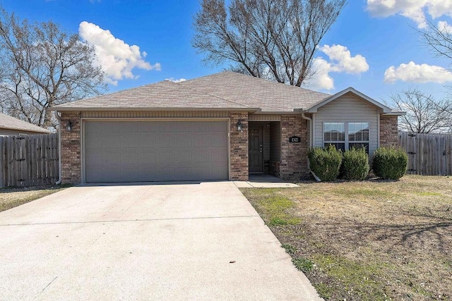 ranch-style home with brick siding, concrete driveway, an attached garage, and fence