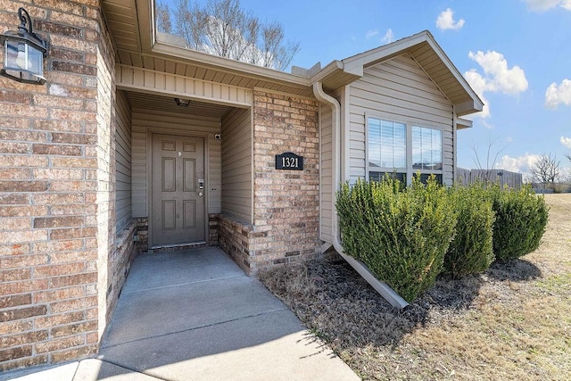 property entrance featuring brick siding