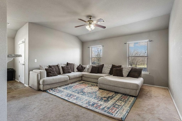 living area with baseboards, lofted ceiling, a ceiling fan, and carpet floors