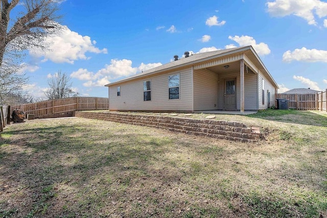 back of property featuring a patio, a lawn, and a fenced backyard