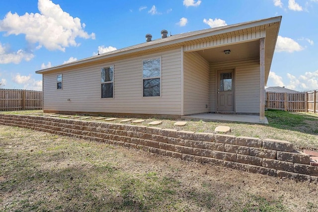 back of house featuring a patio and fence