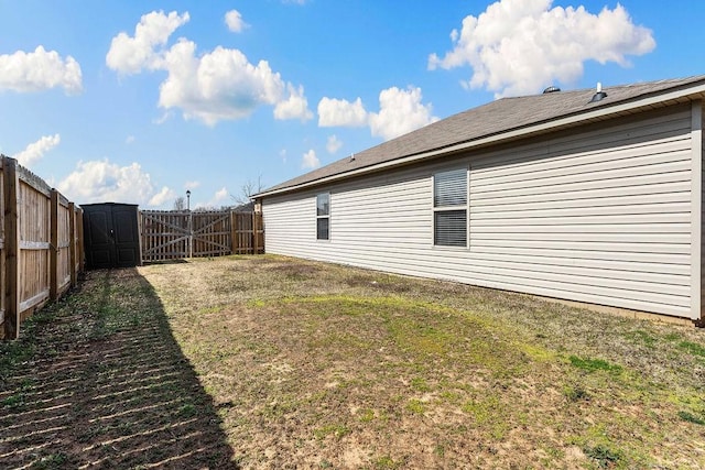 view of yard featuring a fenced backyard and a gate