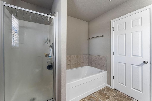 bathroom with a stall shower and a bath