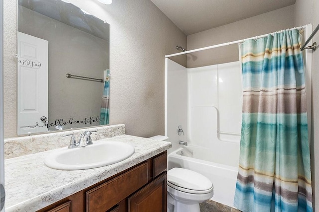 full bathroom featuring toilet, vanity, shower / tub combo, and a textured wall