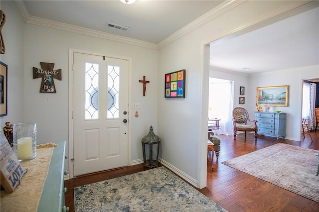 entrance foyer featuring visible vents, dark wood-type flooring, and crown molding