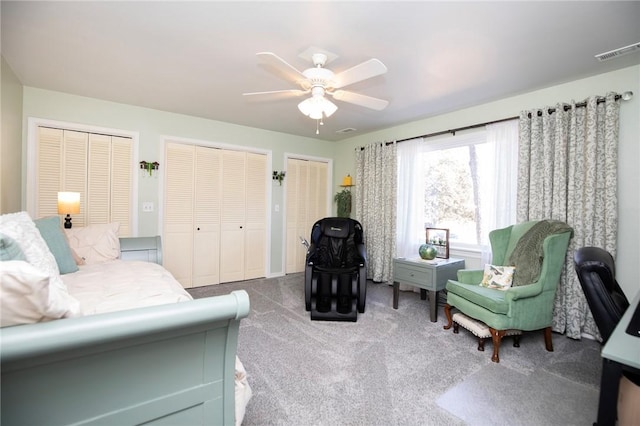 carpeted living room featuring visible vents and a ceiling fan