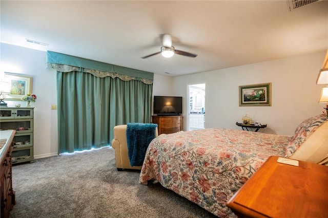 carpeted bedroom featuring visible vents and a ceiling fan