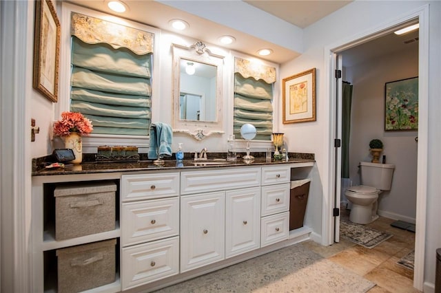 bathroom with visible vents, baseboards, toilet, and vanity