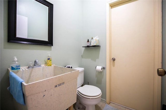 bathroom featuring tile patterned flooring and toilet