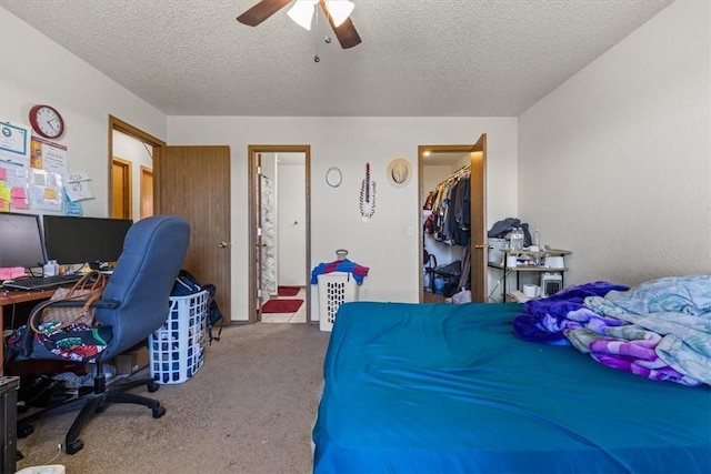 carpeted bedroom with connected bathroom, a ceiling fan, a closet, and a textured ceiling