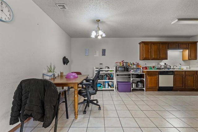 kitchen featuring stainless steel microwave, brown cabinetry, light countertops, light tile patterned floors, and dishwasher