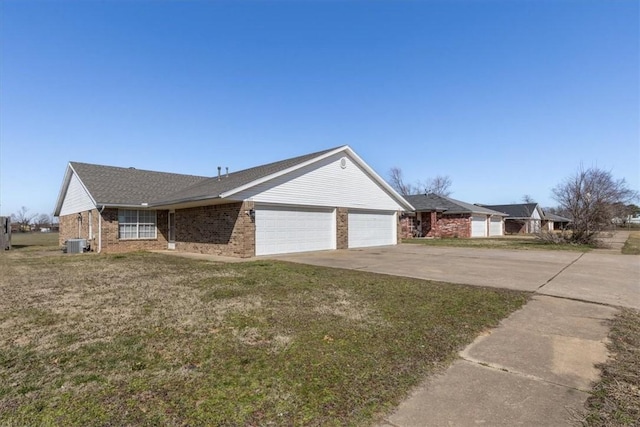 ranch-style house with brick siding, a front yard, central AC unit, driveway, and an attached garage