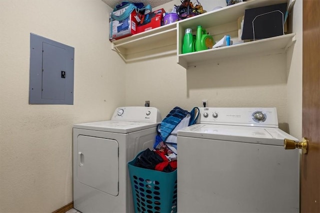 laundry room with laundry area, electric panel, and washer and clothes dryer