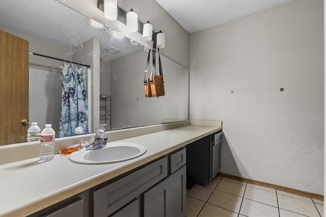 bathroom with tile patterned flooring, baseboards, vanity, a shower with shower curtain, and a textured ceiling