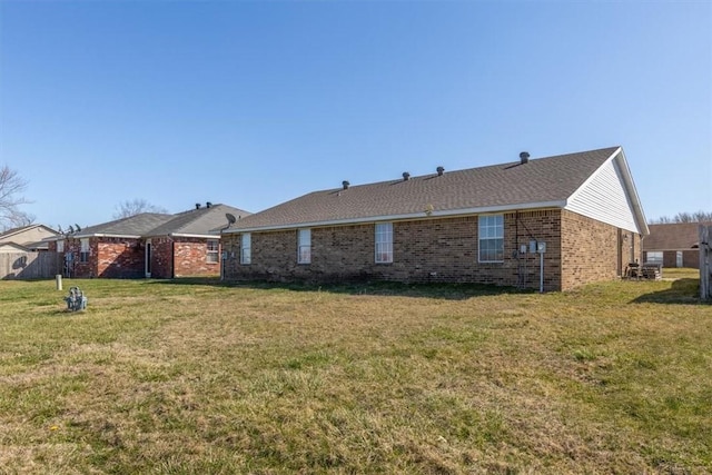 exterior space with brick siding and a front lawn