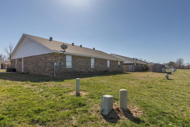 view of property exterior featuring a lawn and brick siding