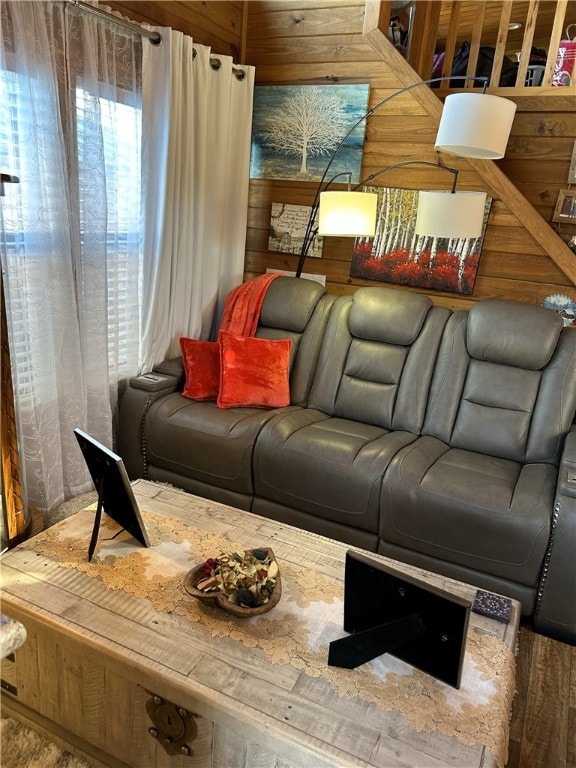 living area featuring wood walls