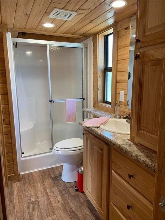 bathroom with wood finished floors, wood ceiling, visible vents, and a stall shower