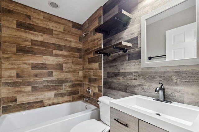 full bathroom featuring toilet, vanity, and shower / tub combination