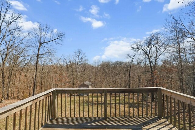 wooden deck with a view of trees