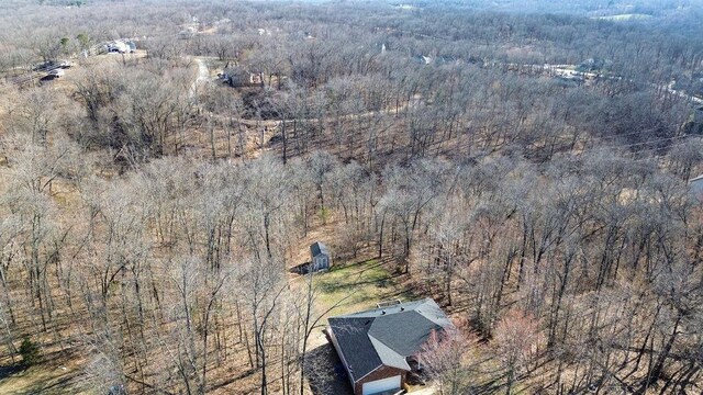 birds eye view of property featuring a wooded view