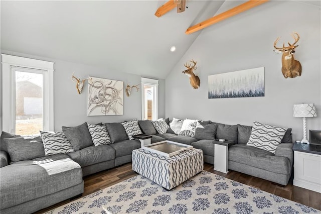 living area with a wealth of natural light, beamed ceiling, high vaulted ceiling, and wood finished floors