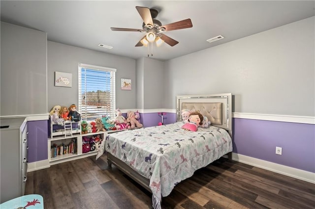 bedroom with visible vents, a ceiling fan, baseboards, and wood finished floors