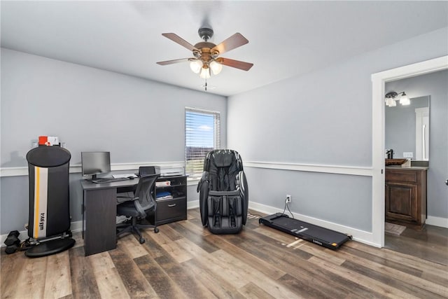 office area with baseboards, wood finished floors, and ceiling fan