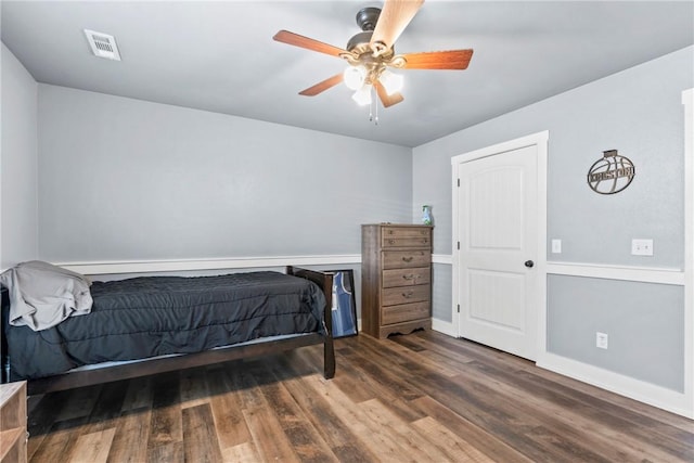 bedroom featuring wood finished floors, visible vents, and ceiling fan