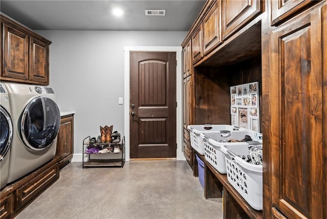 laundry room with cabinet space, separate washer and dryer, visible vents, and baseboards