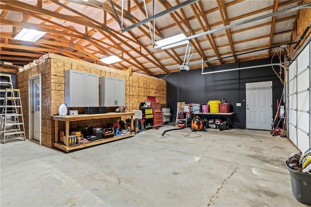 garage featuring a garage door opener and metal wall