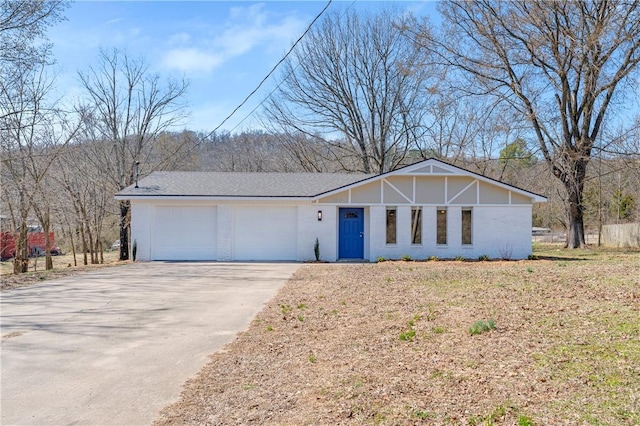 view of front facade featuring concrete driveway and a garage