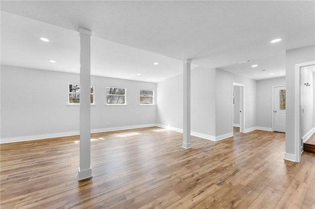 basement featuring visible vents, recessed lighting, light wood-style floors, and baseboards