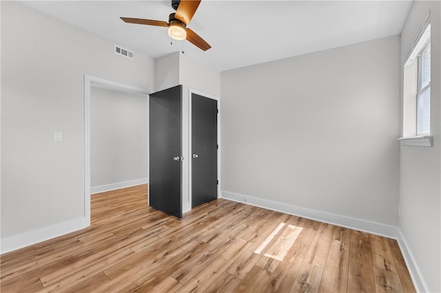 unfurnished bedroom featuring visible vents, baseboards, and light wood-style flooring