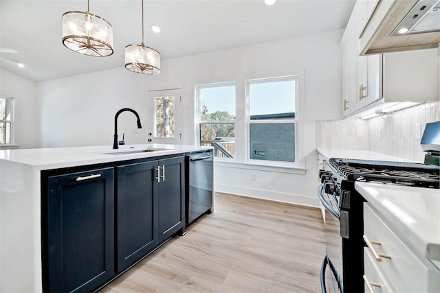 kitchen with black gas stove, under cabinet range hood, dishwasher, light countertops, and a sink