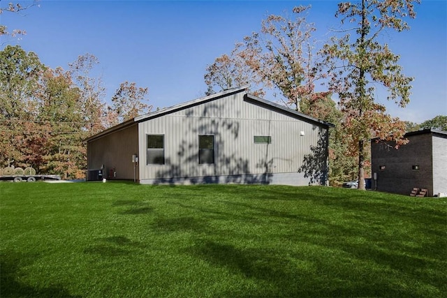 rear view of property with a lawn