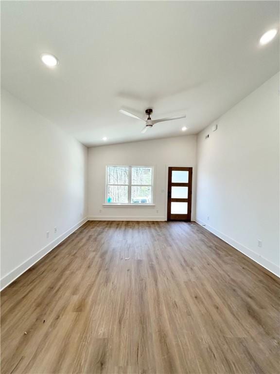 spare room with recessed lighting, wood finished floors, baseboards, and ceiling fan