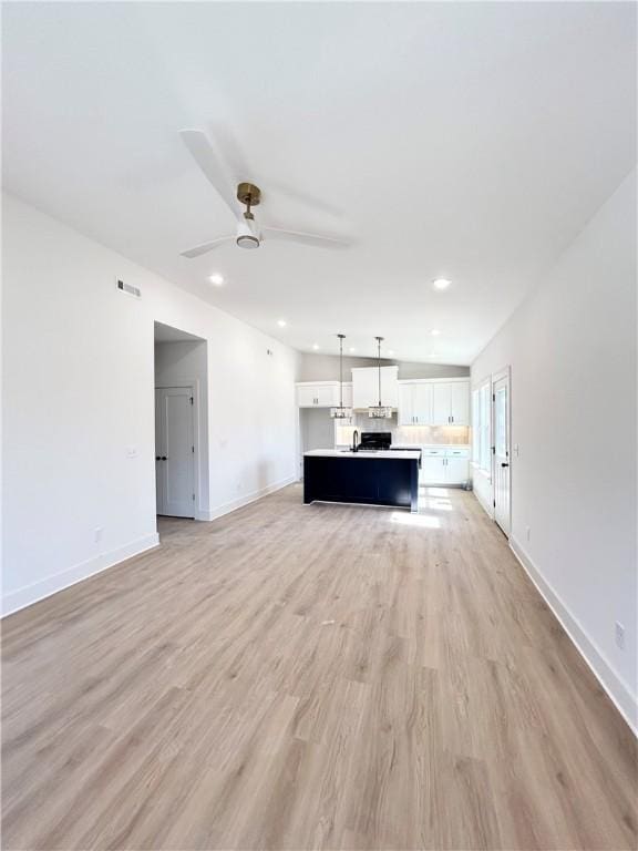 unfurnished living room with visible vents, baseboards, light wood-style flooring, recessed lighting, and ceiling fan