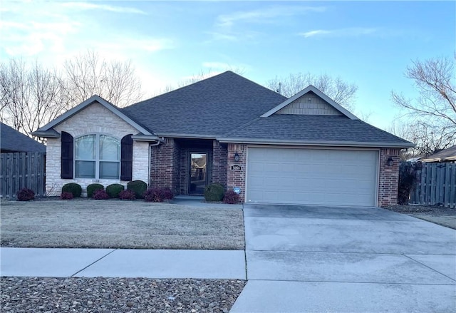 ranch-style house featuring driveway, fence, a shingled roof, a garage, and brick siding