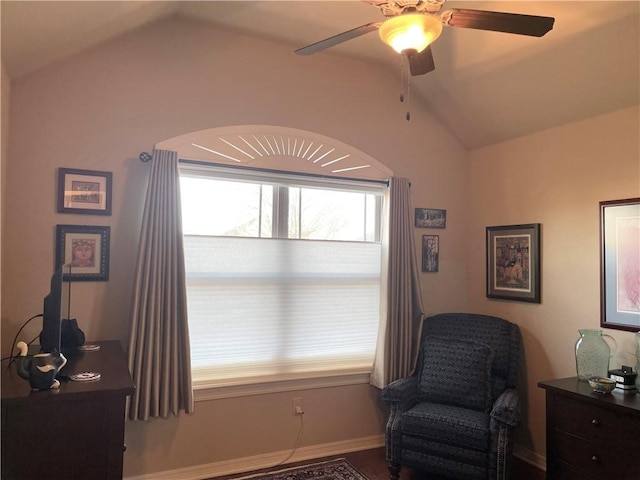 sitting room with a ceiling fan and vaulted ceiling