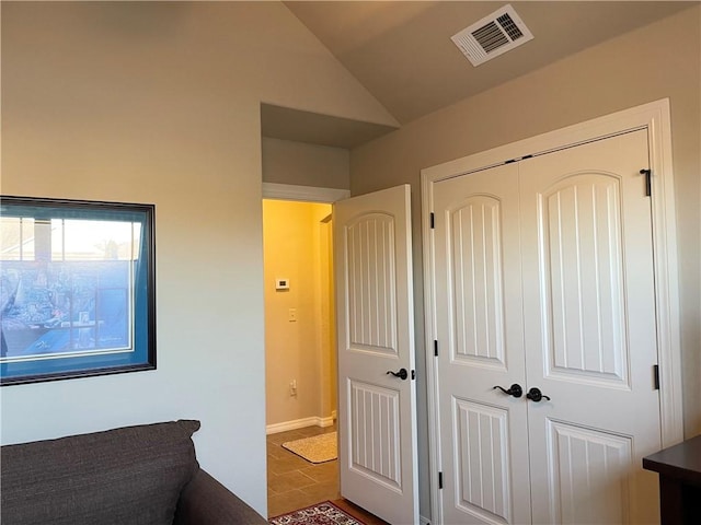 unfurnished bedroom featuring a closet, visible vents, and vaulted ceiling