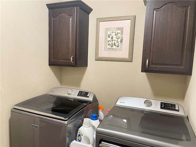 laundry area with cabinet space and separate washer and dryer